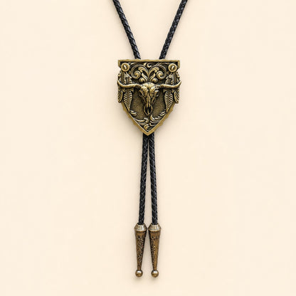 Antique copper longhorn arrowhead bolo tie on a warm ivory background