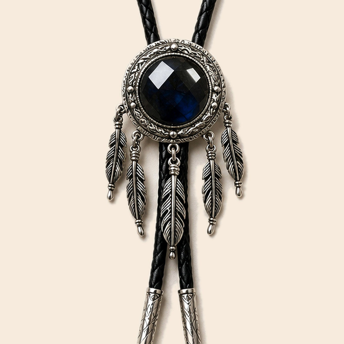 Dreamcatcher labradorite bolo tie with feather accents and black cord on a warm ivory background