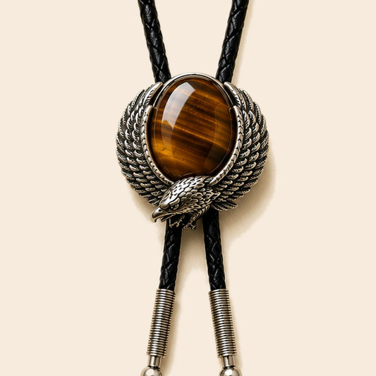 Eagle Eye red tiger eye bolo tie with eagle frame and leather cord on a warm ivory background