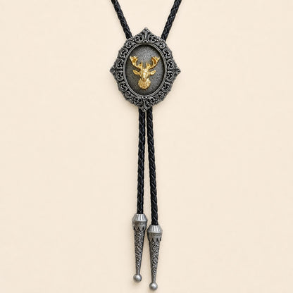 Gilded stag antique silver bolo tie with braided leather cord and engraved silver tips on warm ivory