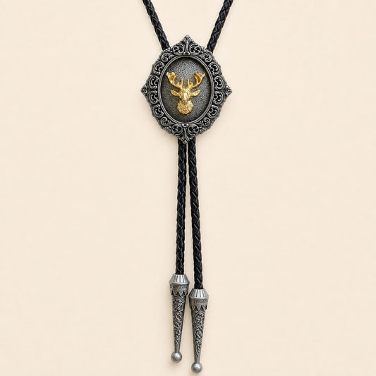 Gilded stag antique silver bolo tie with braided leather cord and engraved silver tips on warm ivory