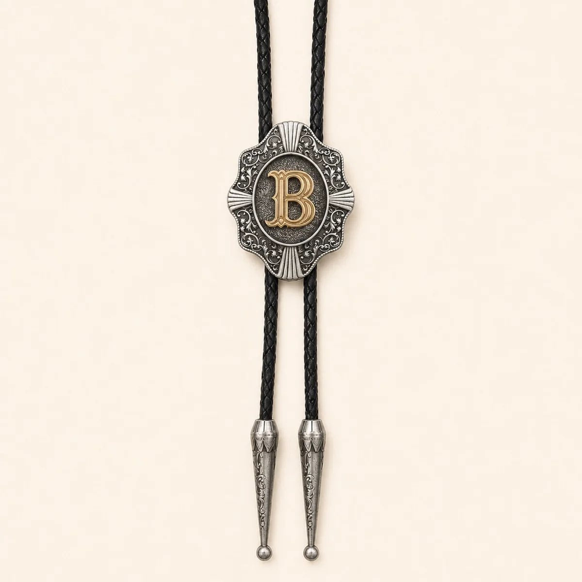 Gold letter B Western bolo tie on a warm ivory background