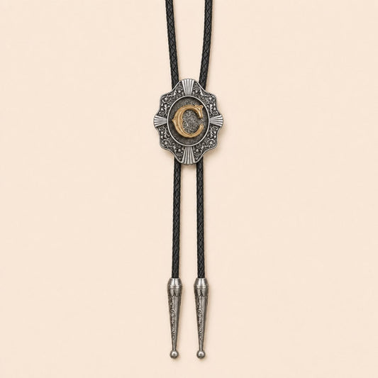 Gold letter C Western bolo tie on a warm ivory background