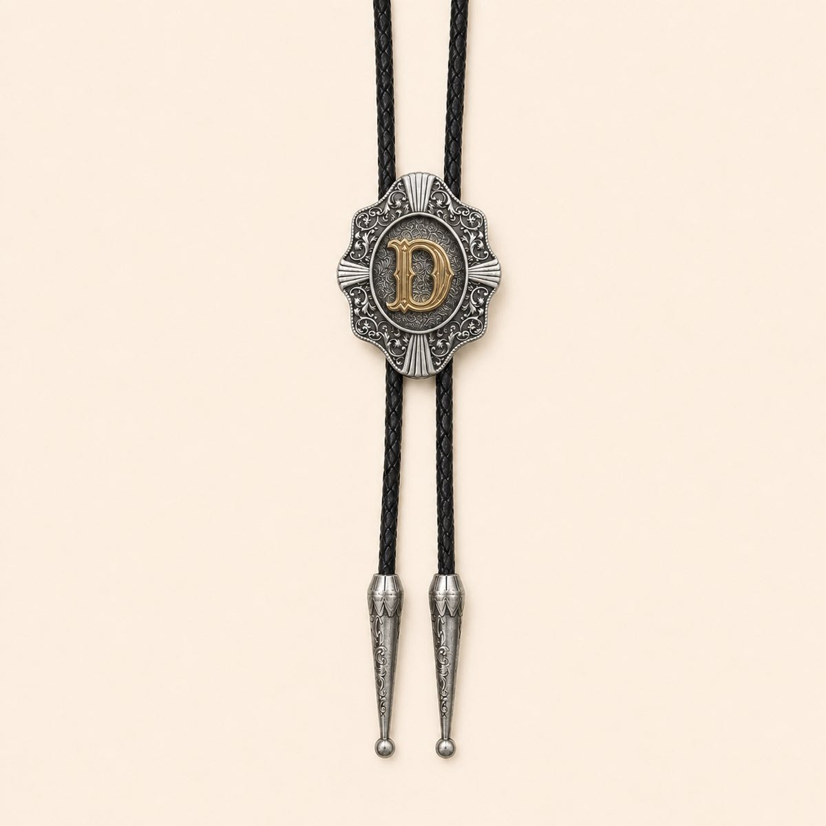 Gold letter D Western bolo tie on a warm ivory background