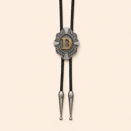 Gold letter D Western bolo tie on a warm ivory background