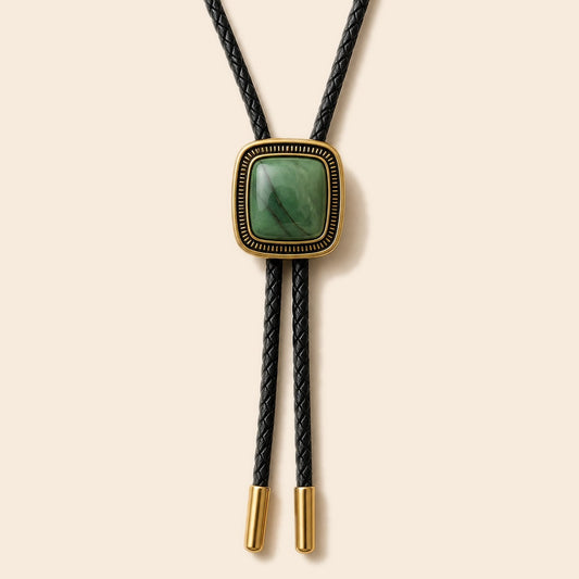 Green jade gold-plated bolo tie on a warm ivory background