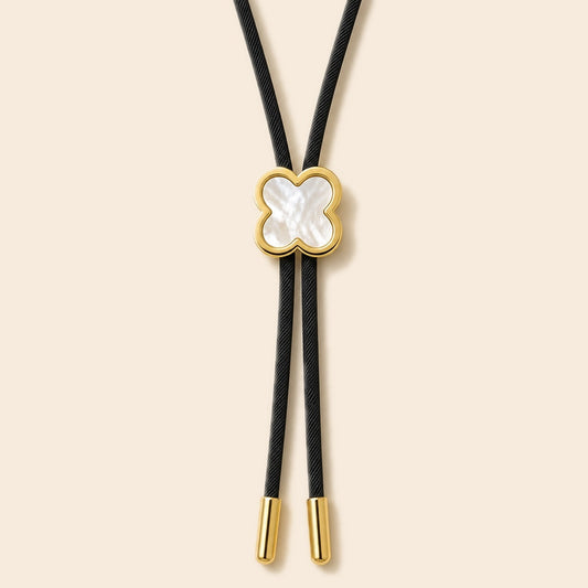 Lucky clover white shell gold-plated bolo tie on a warm ivory background