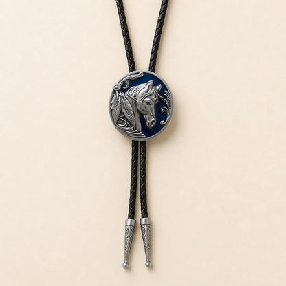 Midnight blue horse head bolo tie with navy enamel medallion on warm ivory background