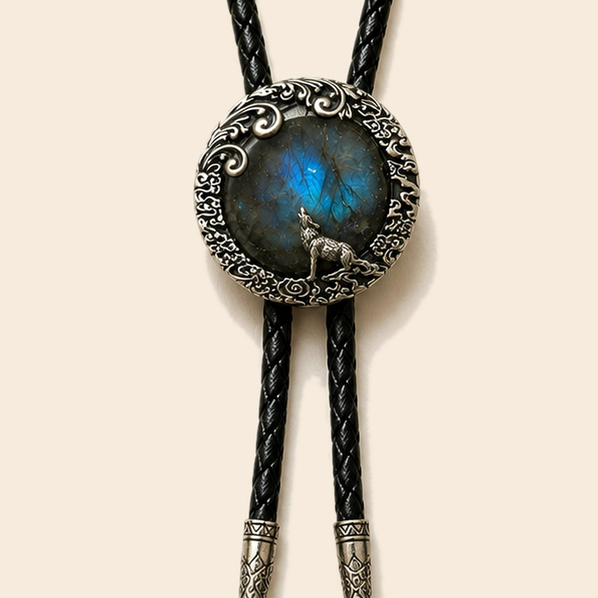 Moonlit wolf labradorite bolo tie with wolf motif and black cord on a warm ivory background