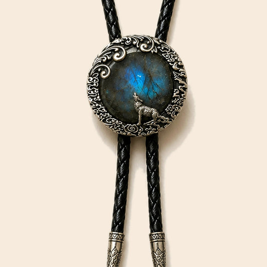 Moonlit wolf labradorite bolo tie with wolf motif and black cord on a warm ivory background