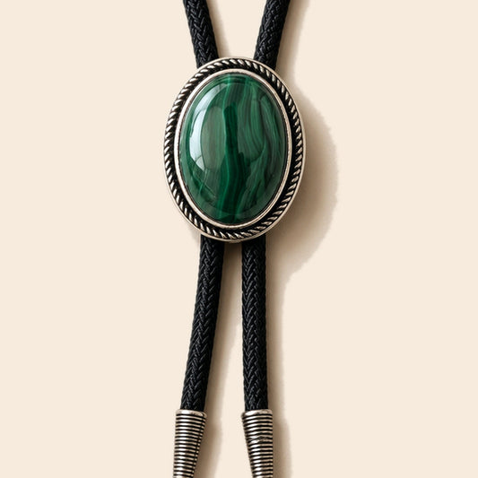 Sage Valley malachite bolo tie with green malachite stone and black cord on a warm ivory background