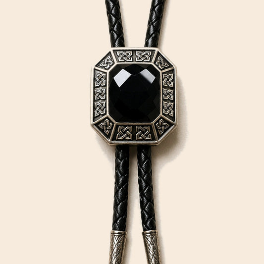 Shadow Ridge black onyx bolo tie with geometric antique silver frame on a warm ivory background