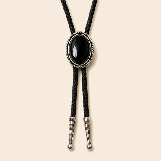 Silver Rope black obsidian bolo tie with antique silver-tone rope frame and Sky System cord on a warm ivory background