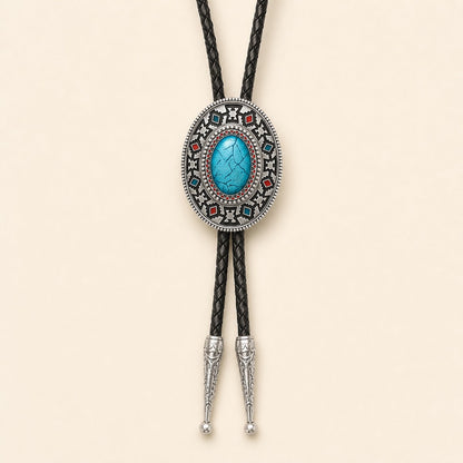 Southwestern enamel bolo tie with blue and red geometric concho on a warm ivory background