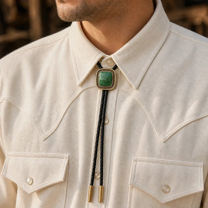 Green jade bolo tie worn with a cream western shirt