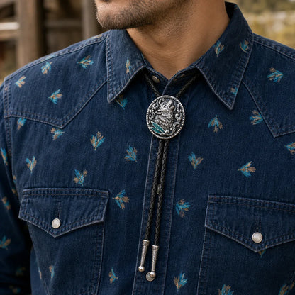 Western wolf bolo tie worn with a dark denim western shirt