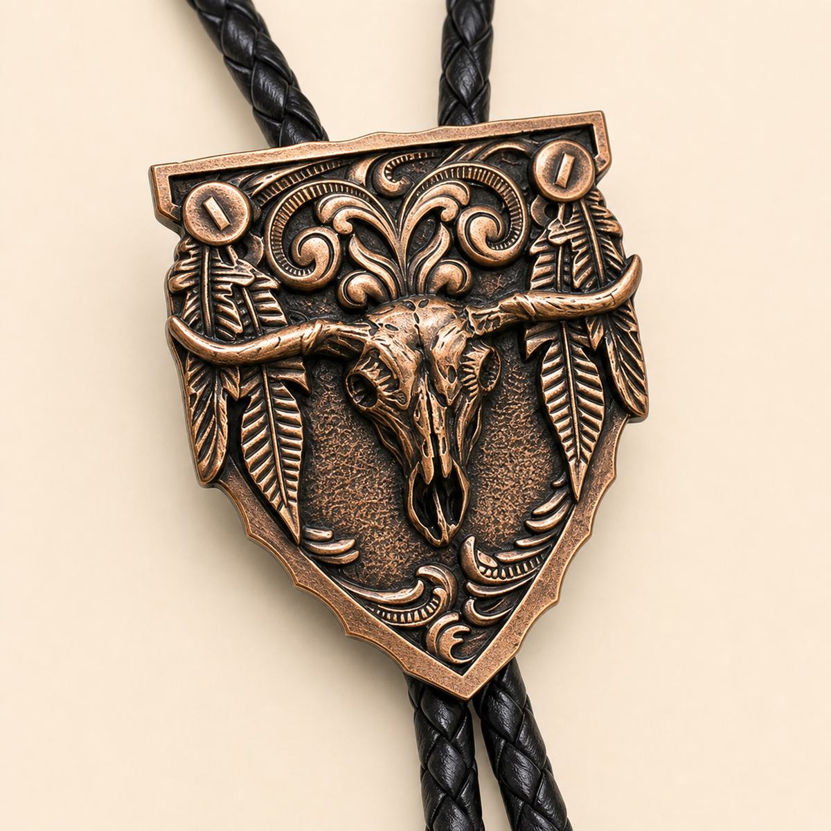 Close detail of the antique copper longhorn skull and feather arrowhead bolo tie