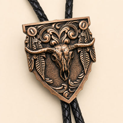 Close detail of the antique copper longhorn skull and feather arrowhead bolo tie