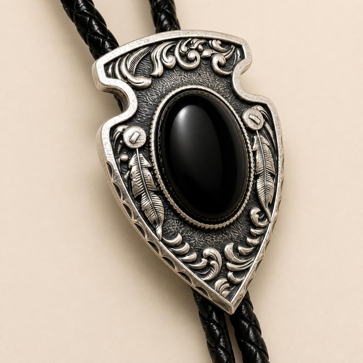 Close detail of arrowhead black obsidian silver bolo concho