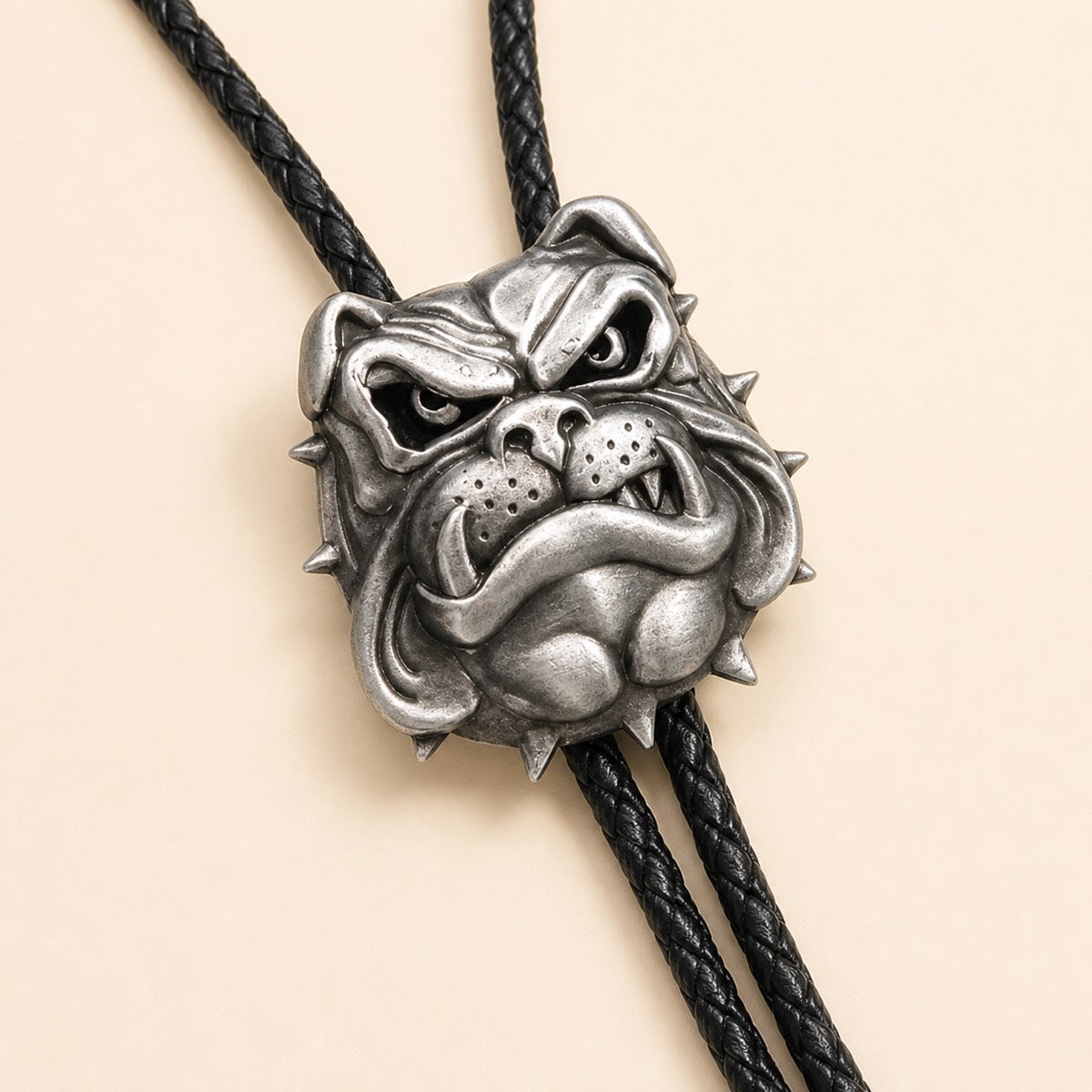 Close-up of antique silver English bulldog bolo tie with sculpted spiked collar detail
