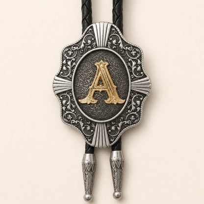 Close-up of raised gold letter A on engraved antique silver Western bolo tie medallion