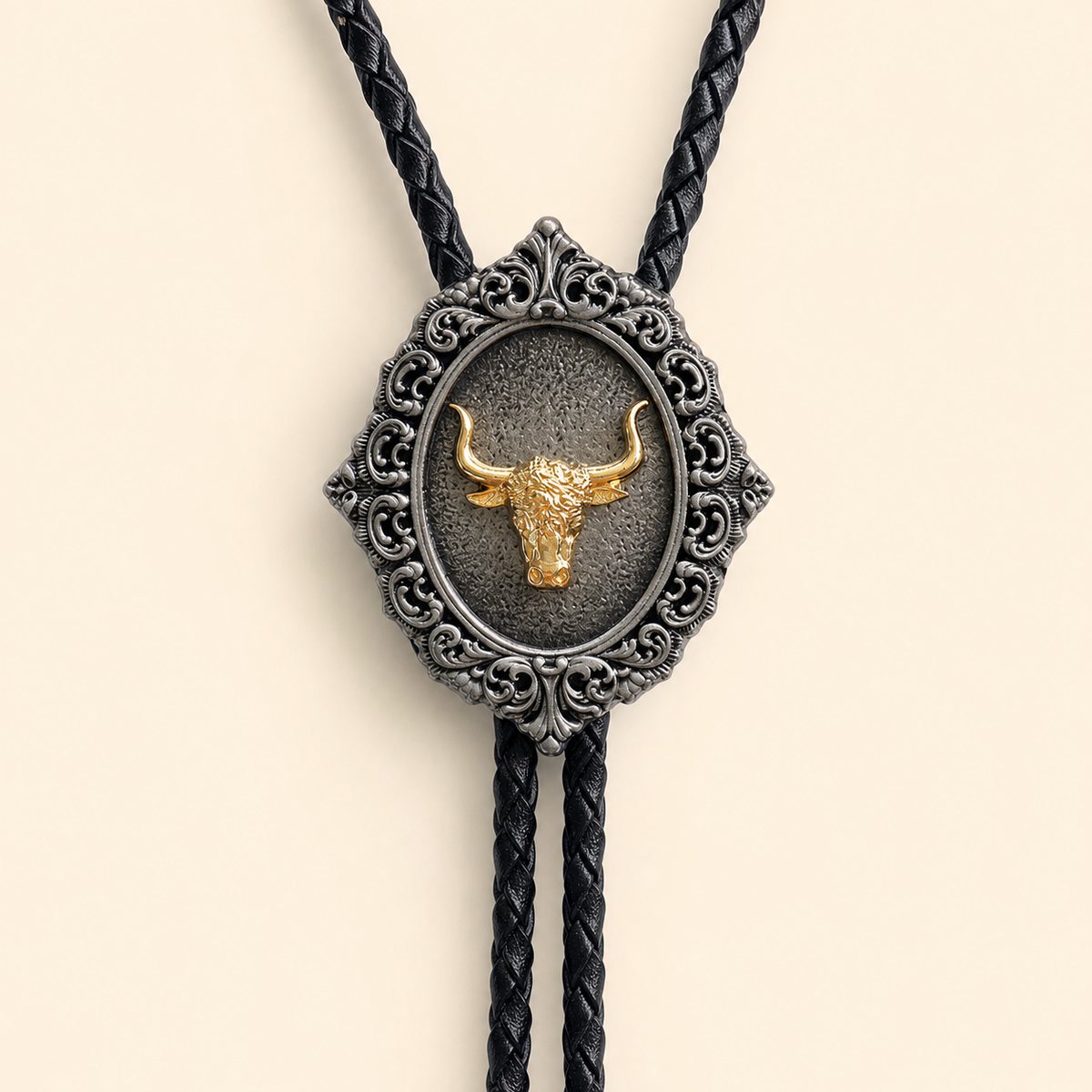 Close-up of the gold longhorn centerpiece in an antique silver scrollwork bolo tie