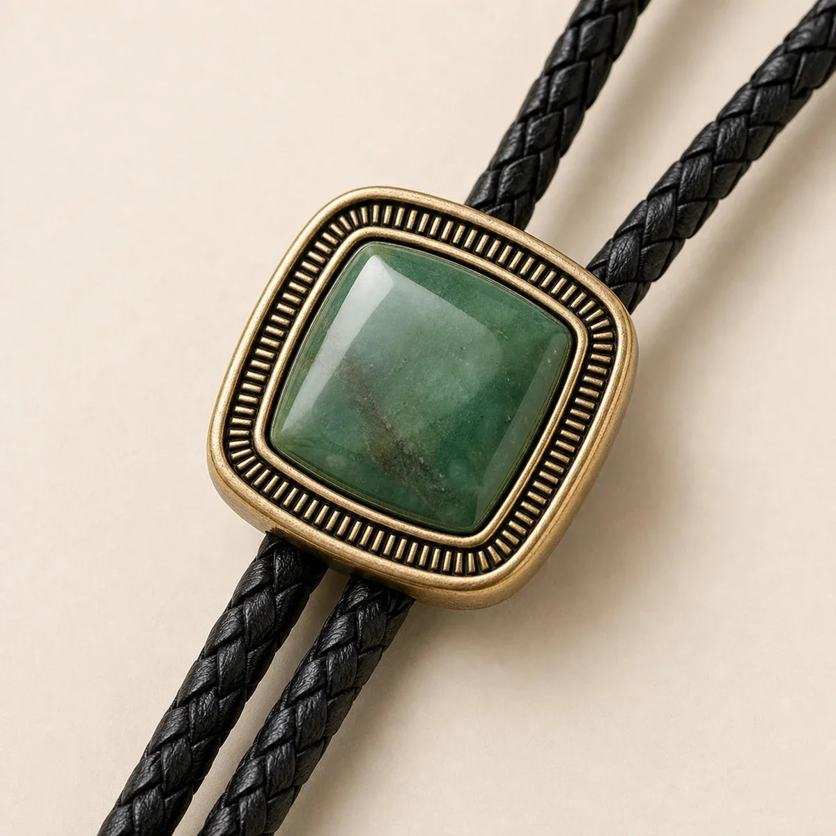 Close-up of green jade bolo tie with antique gold-plated frame