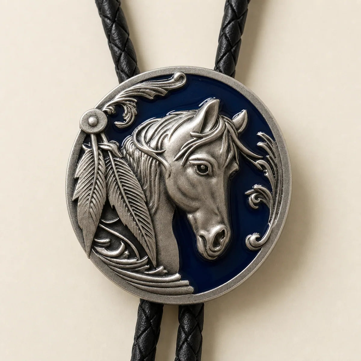 Close-up of antique silver horse head bolo tie with deep blue enamel