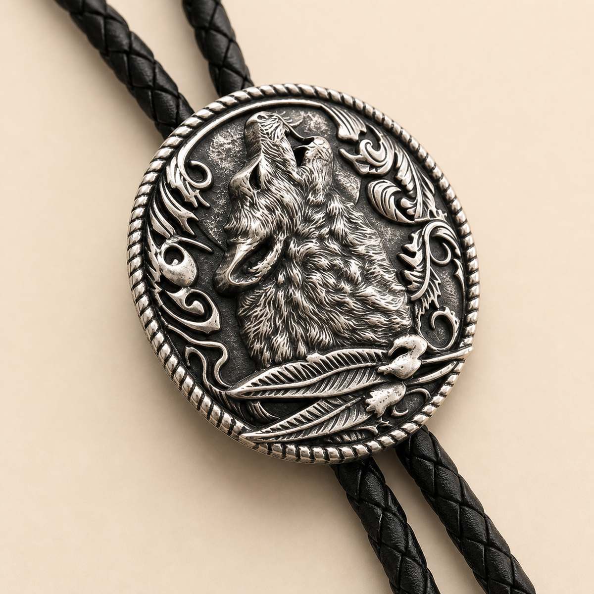 Close detail of moonlit howling wolf silver bolo concho