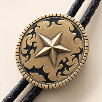 Close-up detail of antique brass Western star bolo tie with scrollwork