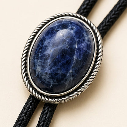 Close-up detail of natural blue stone and antique silver-tone bolo tie frame