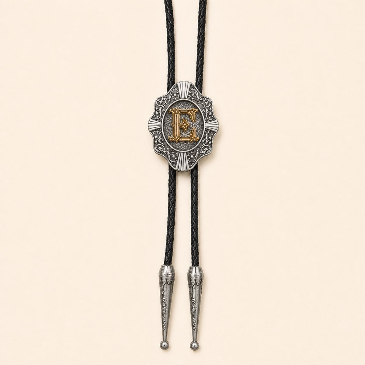 Gold letter E Western bolo tie on warm ivory background