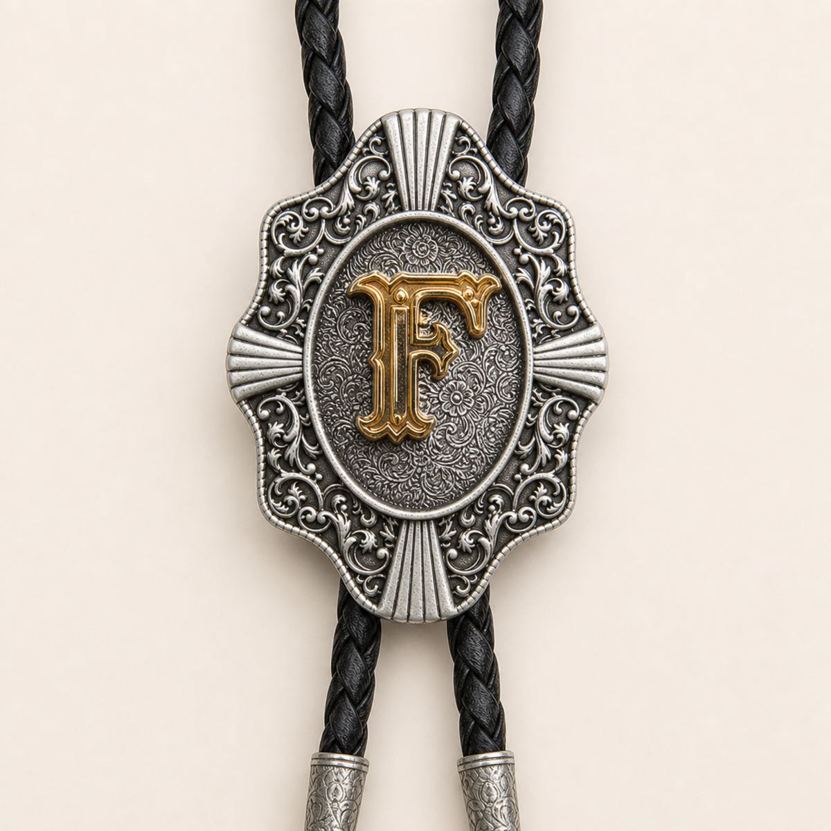 Detailed view of ornate gold letter F bolo tie slide