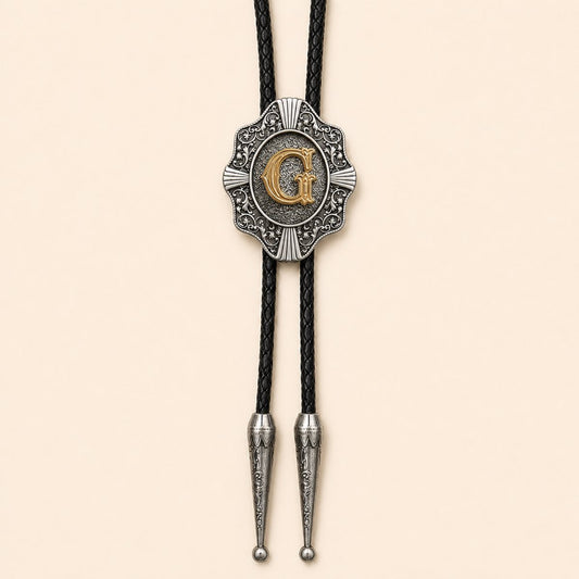 Gold letter G Western bolo tie on warm ivory background