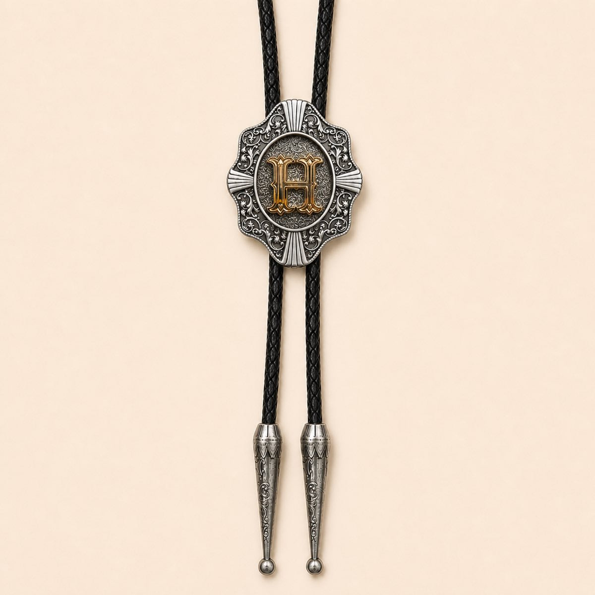Gold letter H Western bolo tie on warm ivory background