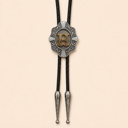 Gold letter H Western bolo tie on warm ivory background