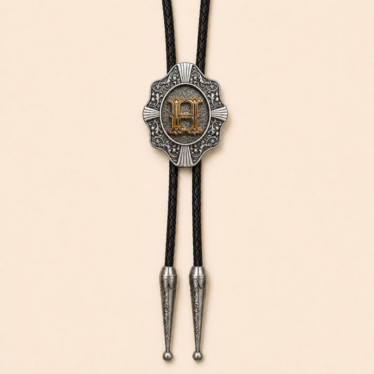 Gold letter H Western bolo tie on warm ivory background
