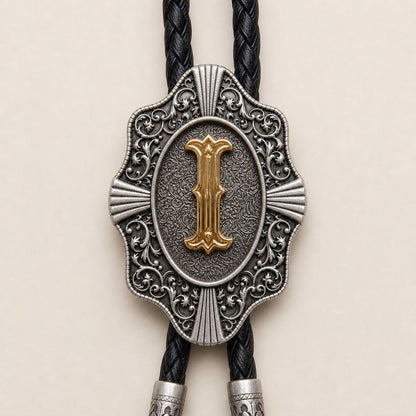 Detailed view of ornate gold letter I bolo tie slide