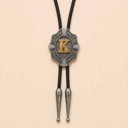 Gold letter K Western bolo tie full product on warm ivory background