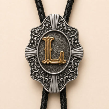 Close-up detail of ornate gold letter L bolo tie slide
