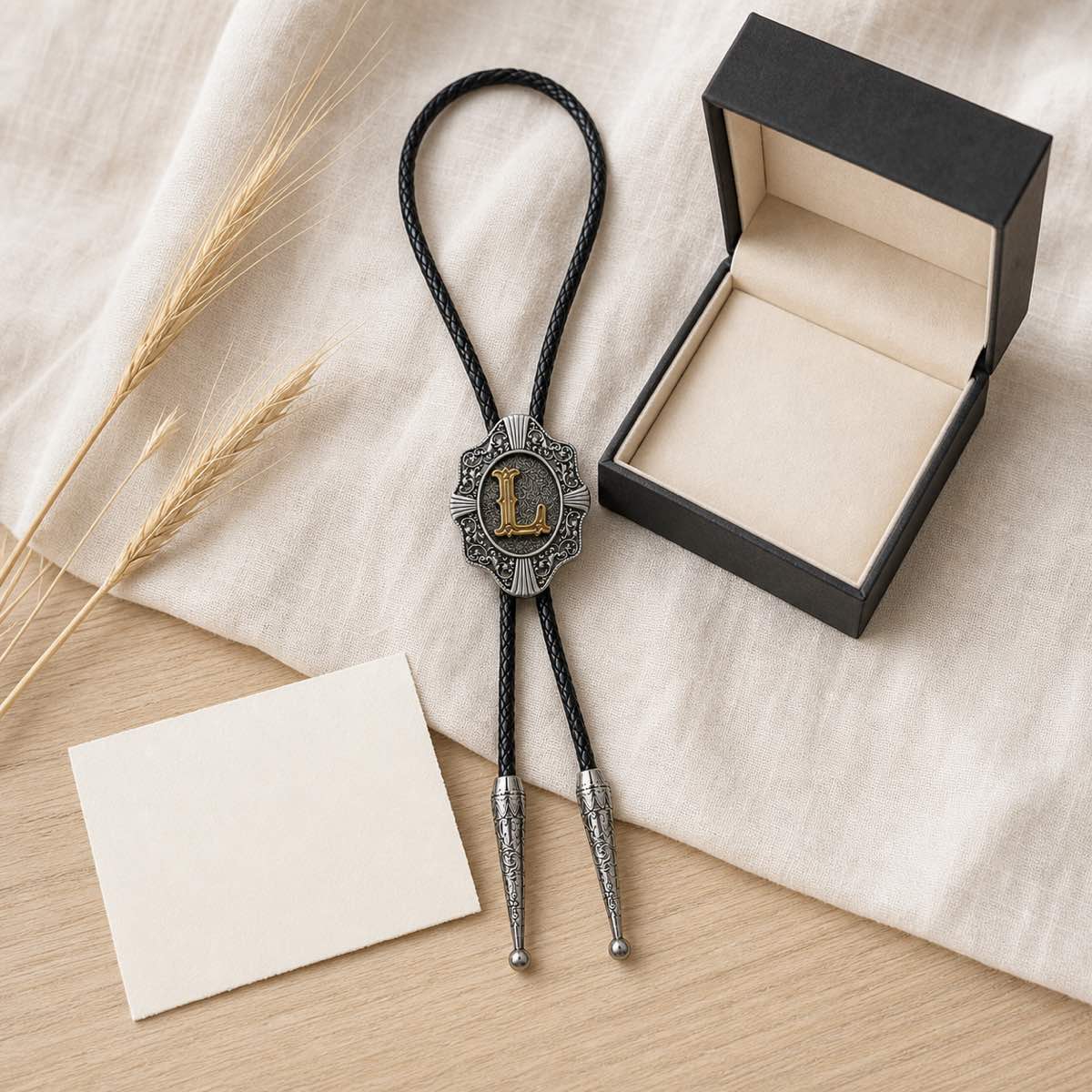 Gold letter L bolo tie presented as a wedding or anniversary gift