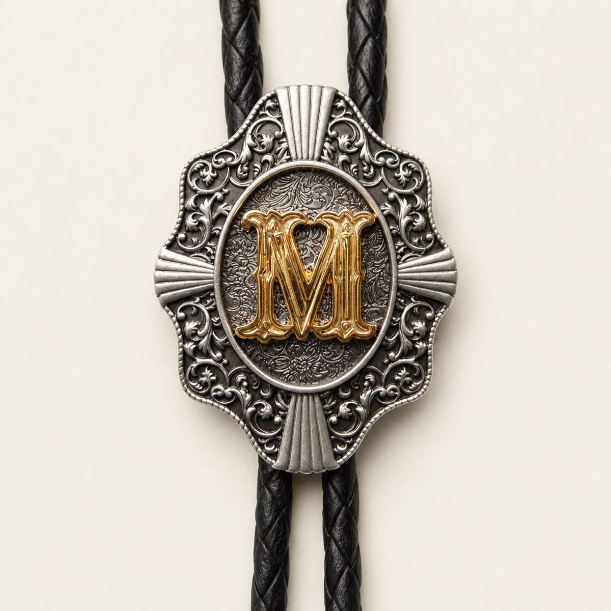 Gold letter M bolo tie engraved metal detail