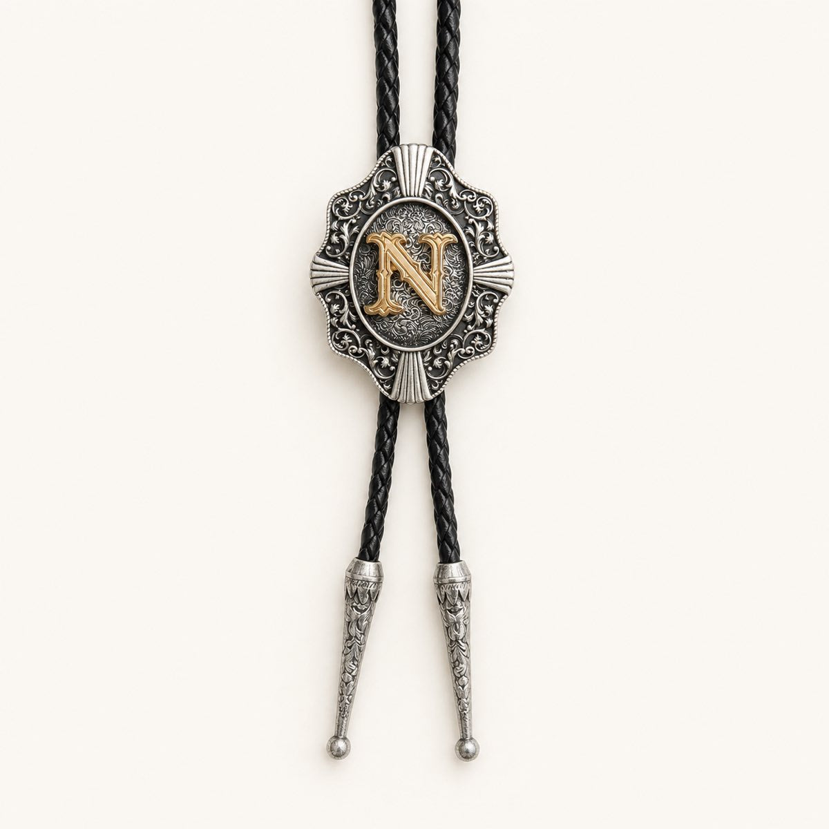 Gold letter N western bolo tie on ivory background