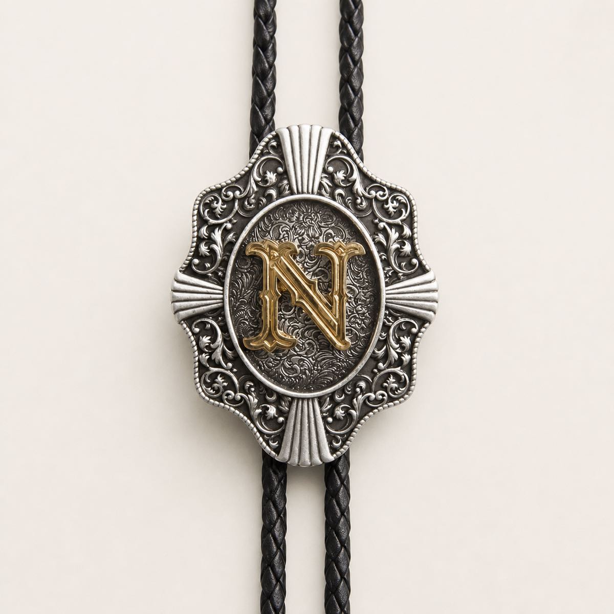 Gold letter N bolo tie engraved metal detail