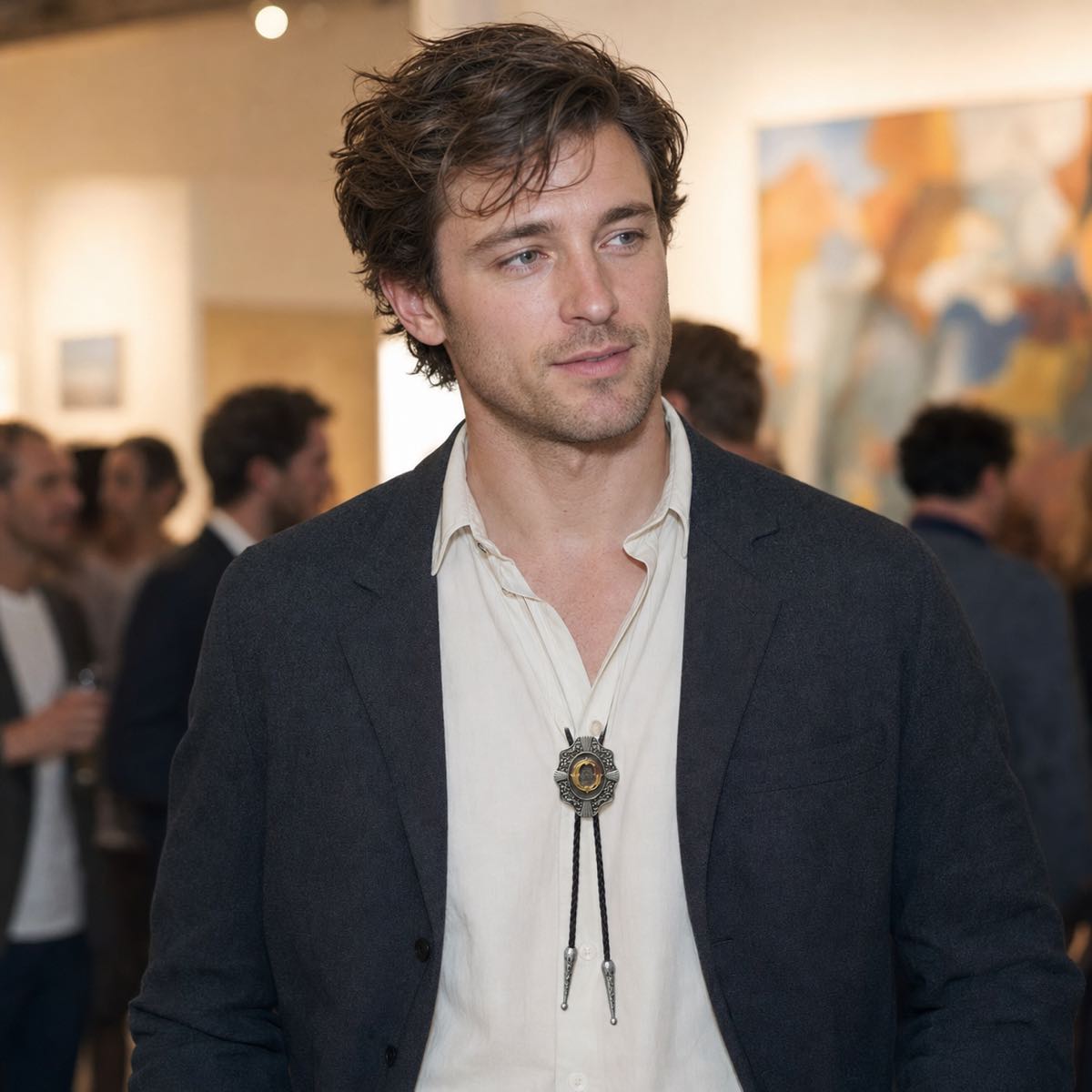 Young man wearing gold letter O bolo tie at an art gallery