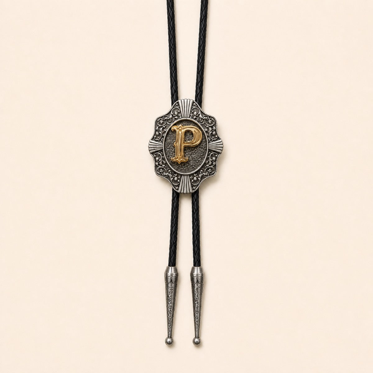 Gold letter P western bolo tie on pale warm ivory background
