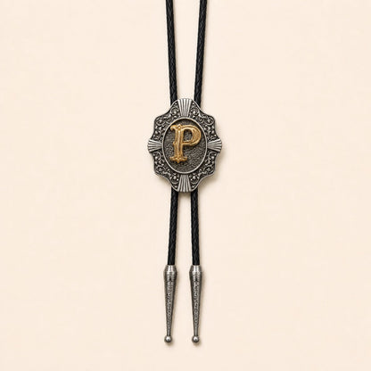 Gold letter P western bolo tie on pale warm ivory background