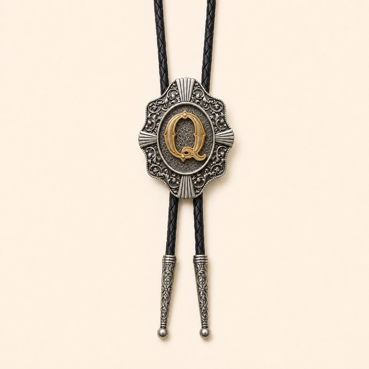 Gold letter Q western bolo tie on pale warm ivory background