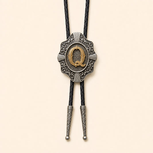 Gold letter Q western bolo tie on pale warm ivory background