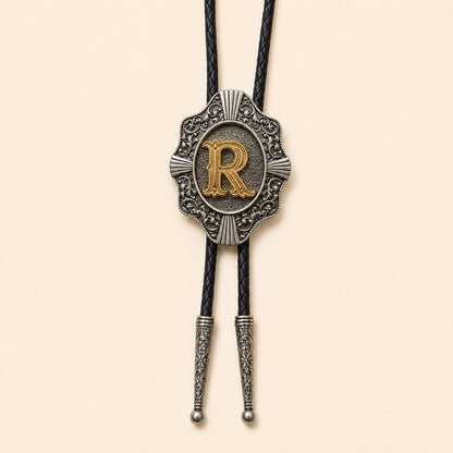 Gold letter R western bolo tie on pale warm ivory background